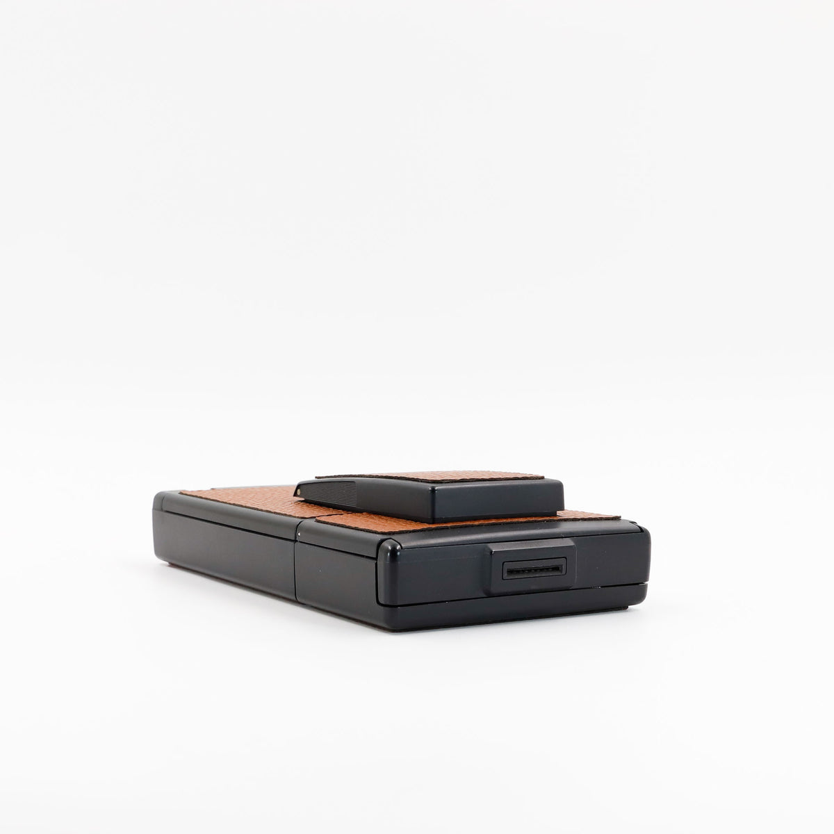 Polaroid SX-70 Alpha instant camera in black with restored caramel leather, converted to accept 600 film