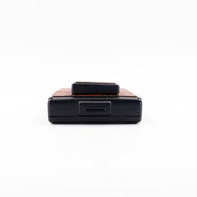 Polaroid SX-70 Alpha instant camera in black with restored caramel leather, converted to accept 600 film