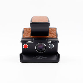 Polaroid SX-70 Alpha instant camera in black with restored caramel caramel leather, converted to accept 600 film