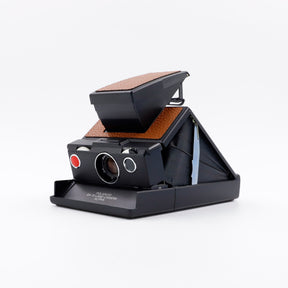 Polaroid SX-70 Alpha instant camera in black with restored caramel leather, converted to accept 600 film