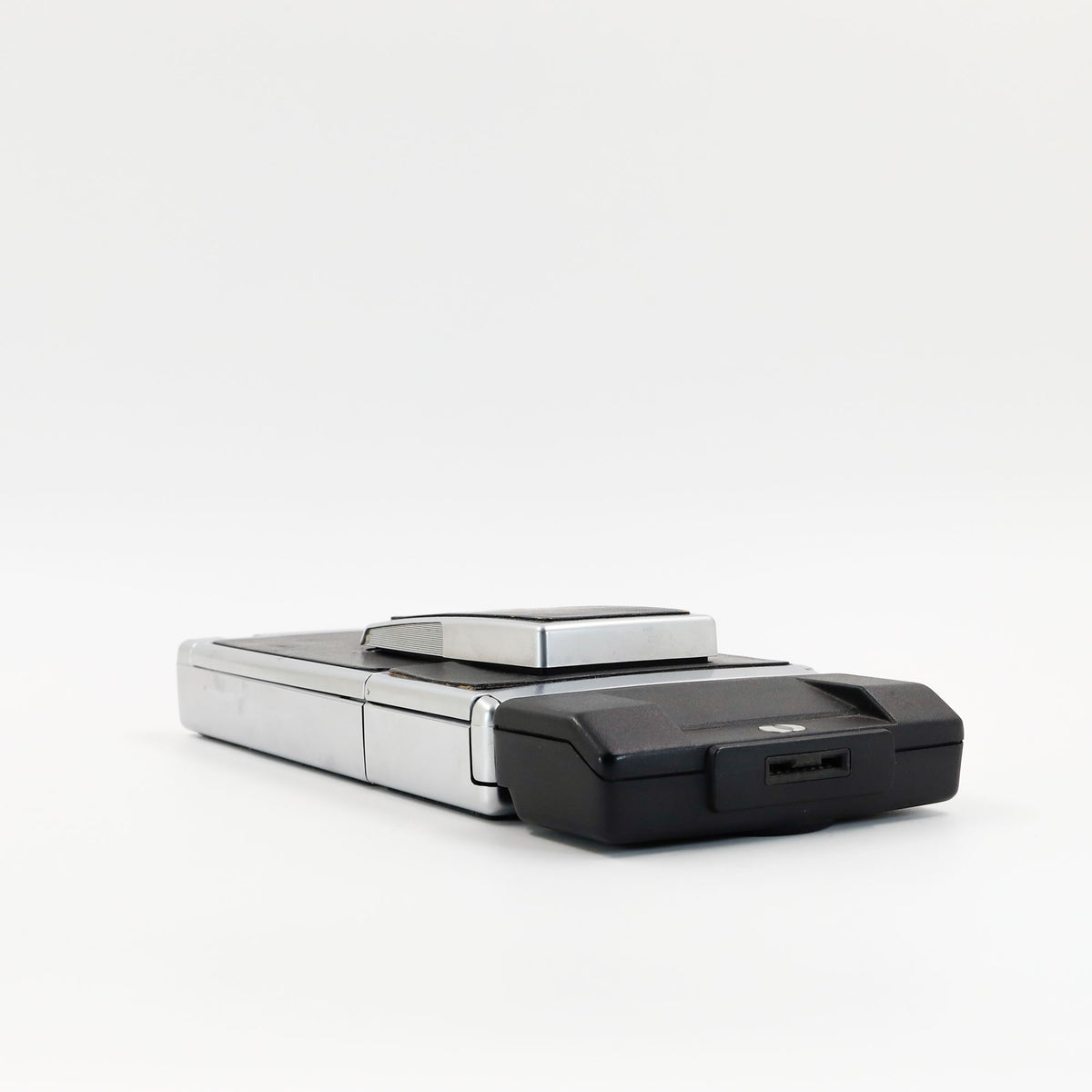 Polaroid SX-70 Land Sonar instant camera in silver with restored black leather, converted to accept 600 film