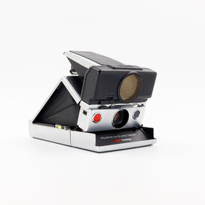 Polaroid SX-70 Land Sonar instant camera in silver with original black leather, converted to accept 600 film
