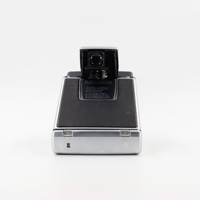 Polaroid SX-70 Land Sonar instant camera in silver with original black leather, converted to accept 600 film